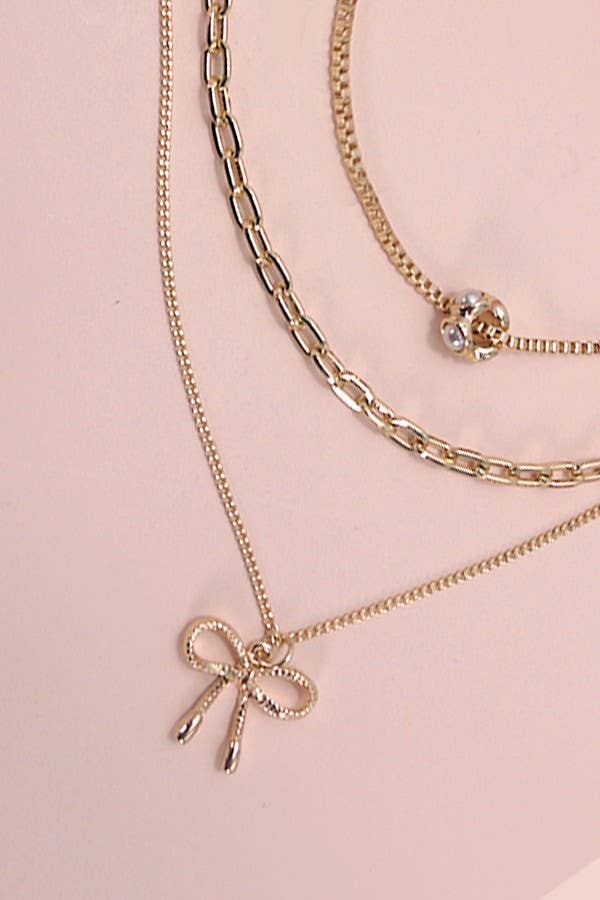 GOLD MULTI LAYER PEARL BOW CAHRM NECKLACE