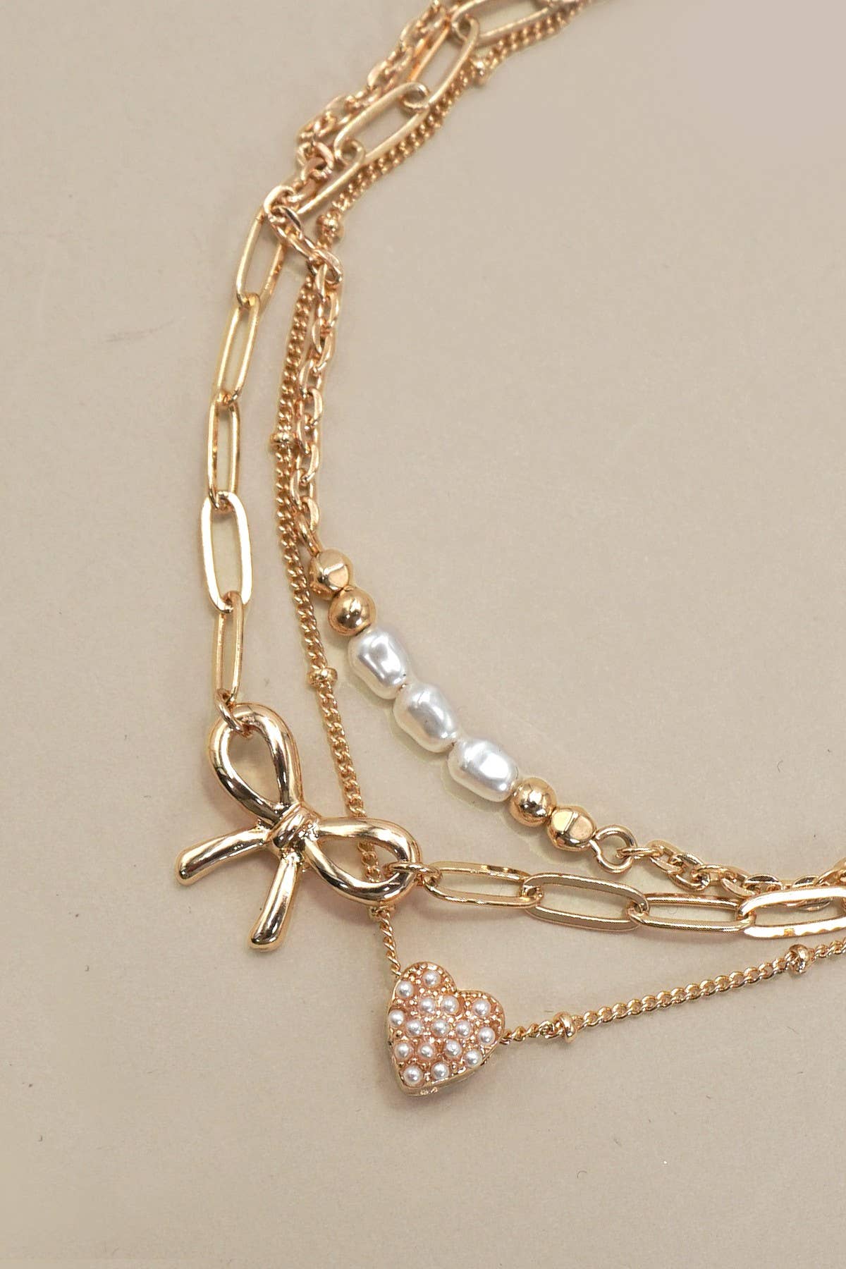 CHARM BRACELET-MULTI LAYER BOW PERAL HEART CHARMS